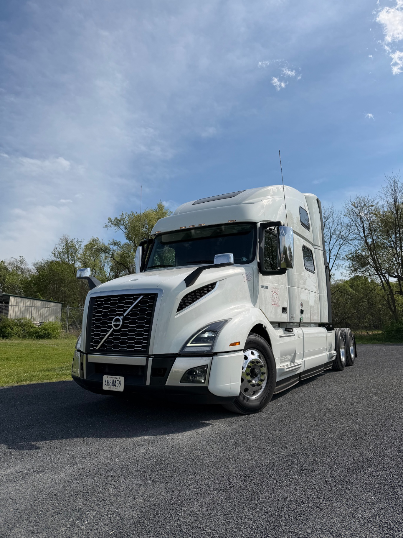 White Volvo tractor under blue sky